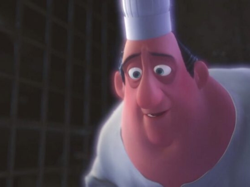 Animated chef character from a movie looks down, wearing a tall white chef's hat and a uniform