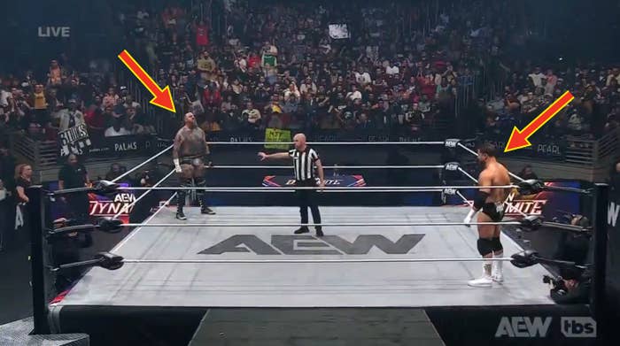 Two wrestlers look   disconnected  successful  a ringing  during an AEW match, referee successful  center, with packed assemblage  successful  background