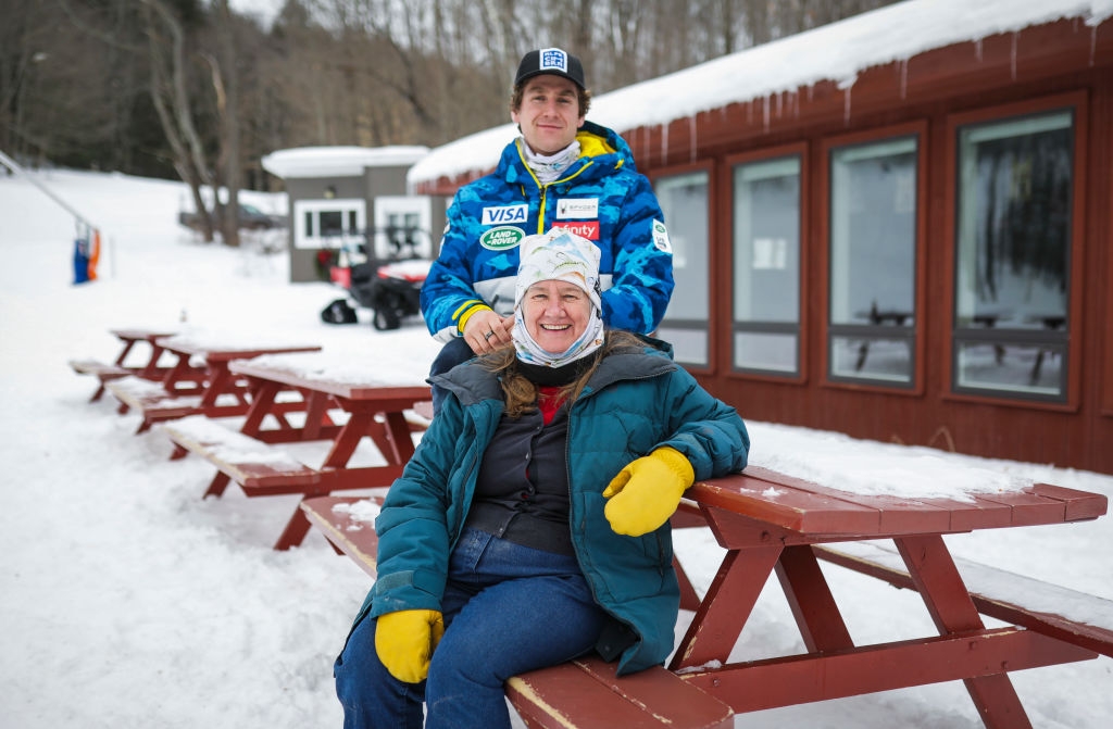 Ryan and Barbara posing connected  a snow-covered picnic table
