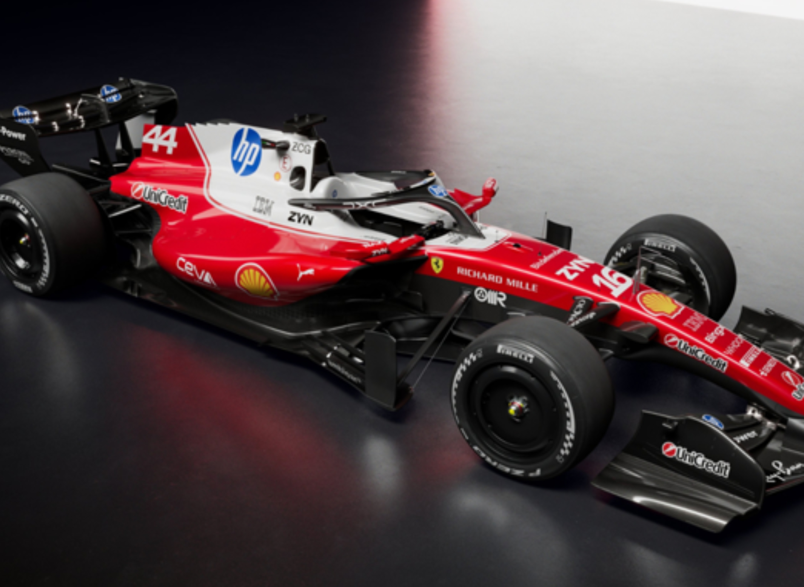 A sleek Formula 1 race car with prominent sponsor logos is displayed, showcasing aerodynamic design and advanced engineering