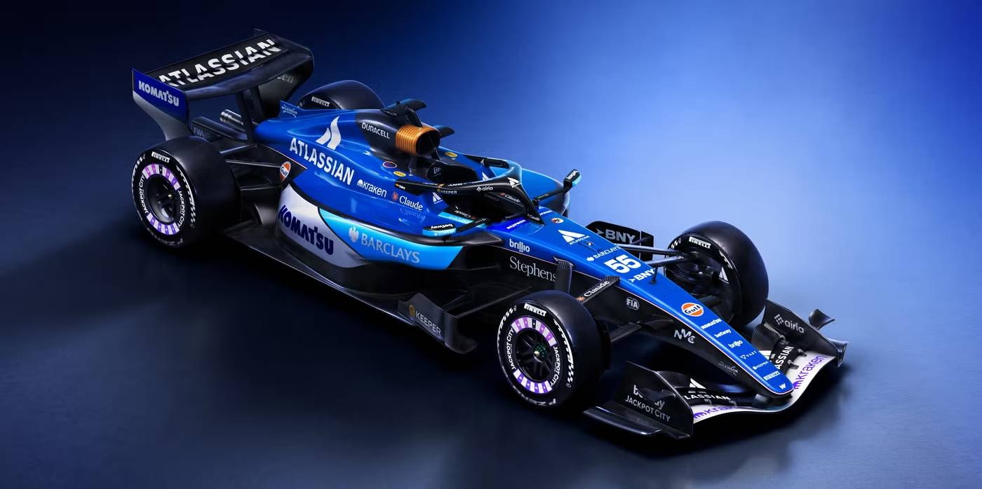 Formula 1 racing car with prominent sponsor logos on the body, displayed against a plain backdrop