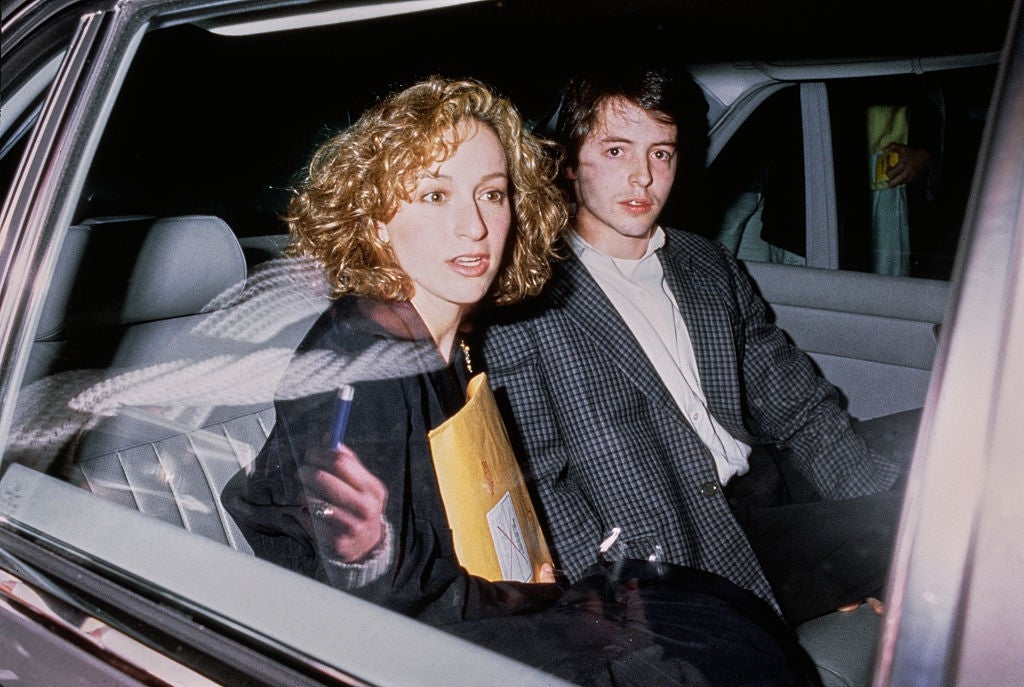 Two individuals beryllium   successful  a car. The pistillate   holds an envelope and wears a blazer; the antheral   wears a checkered suit. They look  to beryllium  engaged successful  conversation