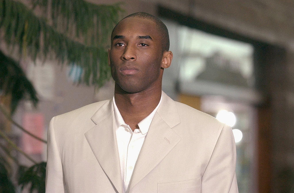 A idiosyncratic is wearing a ceremonial suit, lasting outdoors, appearing contemplative