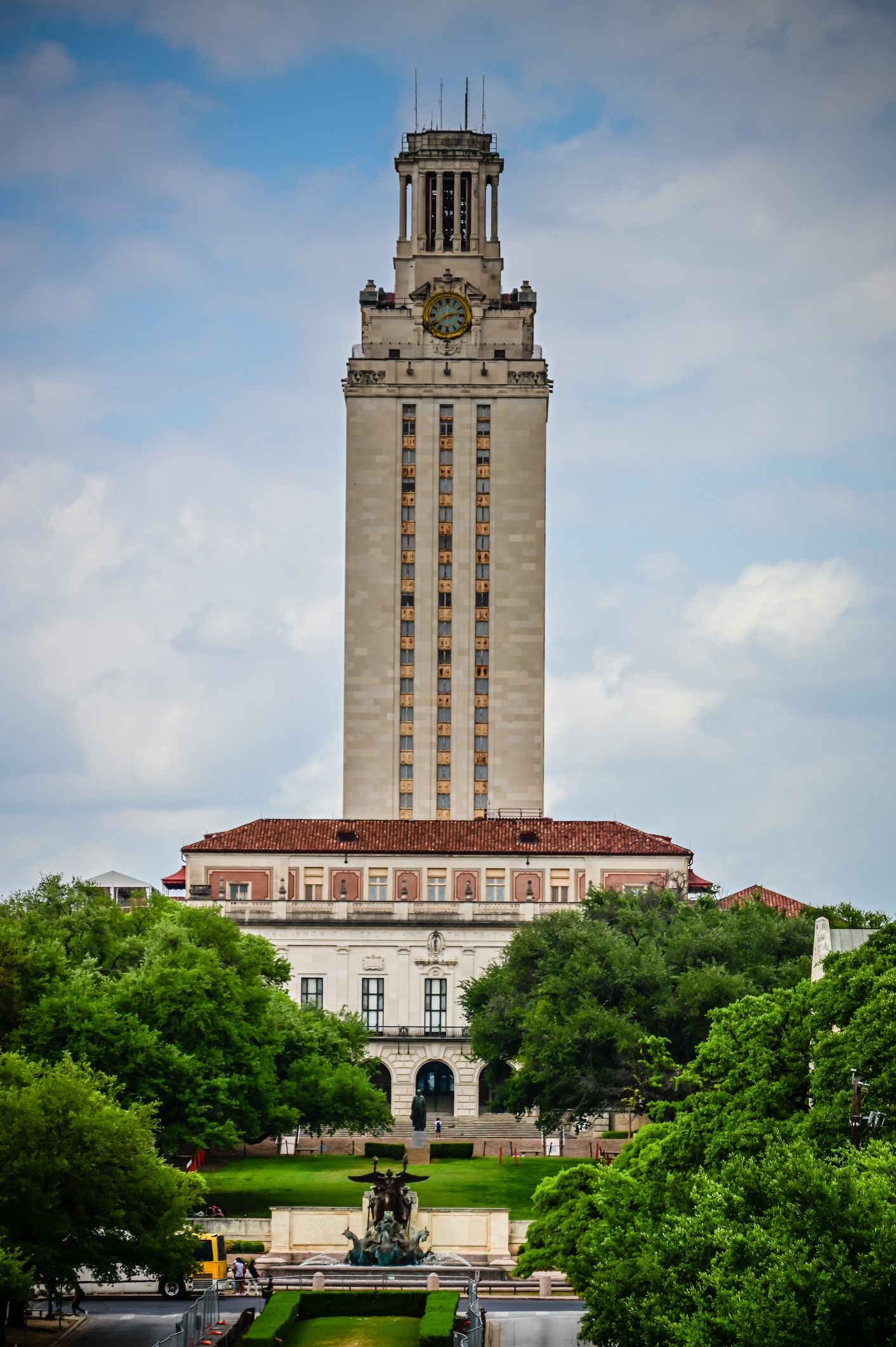 The representation shows the University of Texas Tower, a tall, iconic gathering surrounded by trees and a fountain successful the foreground