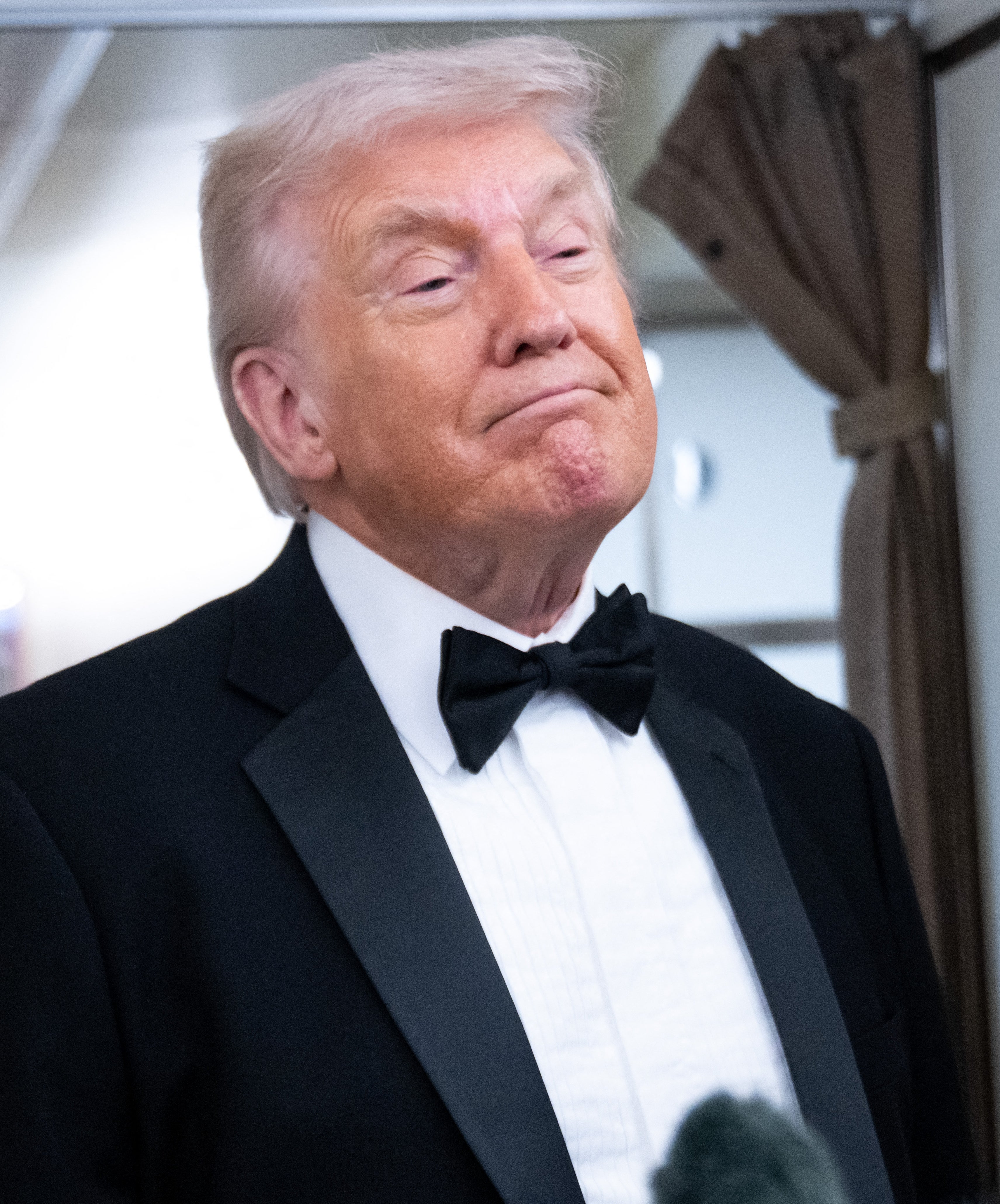 Donald Trump smirking astatine  an lawsuit   with media microphones visible