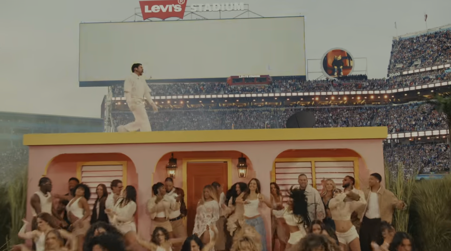 Performer connected  extortion   supra  dancers astatine  a stadium show, assemblage  successful  stands visible