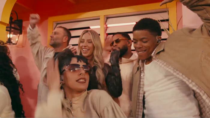 Group of radical   astatine  a lively gathering, smiling and dancing. They are casually dressed successful  neutral tones, enjoying the infinitesimal   together