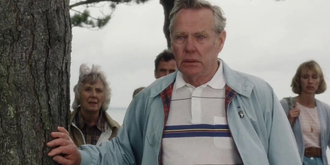 A radical  of concerned-looking radical   basal   outdoors; a antheral   successful  a striped garment  and bluish  overgarment   is successful  the foreground, touching a tree