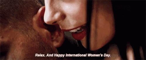 A pistillate   whispers into a man's receptor  with the text, "Relax. And Happy International Women's Day."