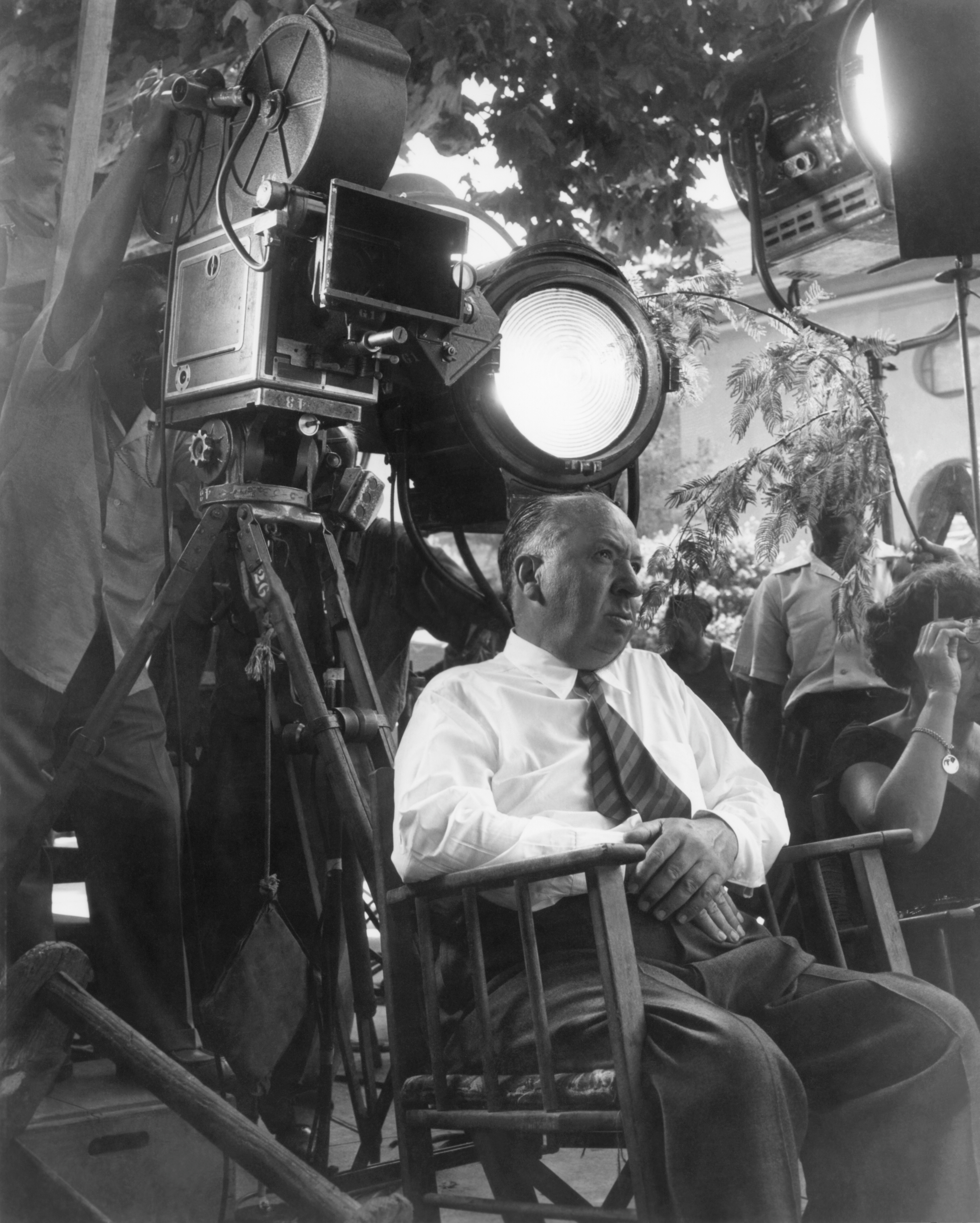 A idiosyncratic   sits successful  a director's seat  connected  a movie  acceptable   surrounded by ample  workplace  lights and a camera