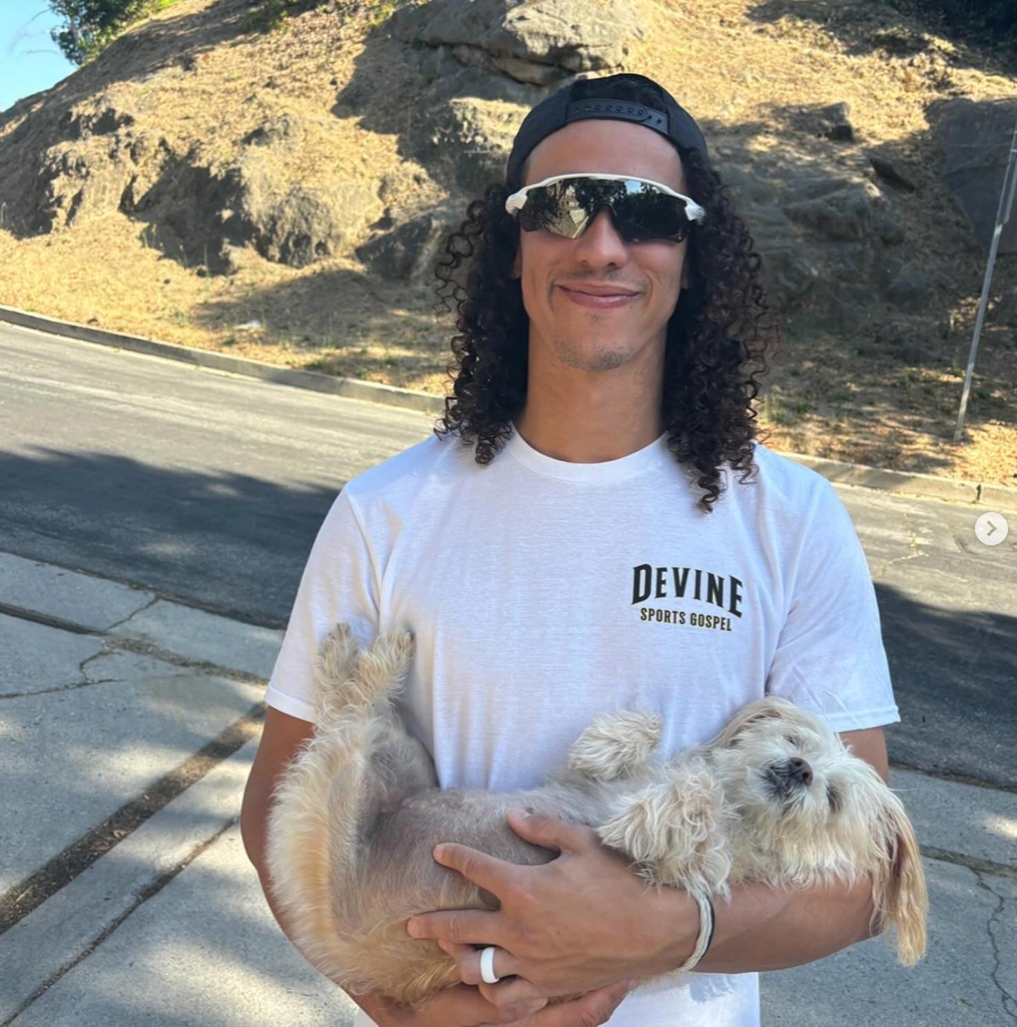 Cole holidng a tiny  dog