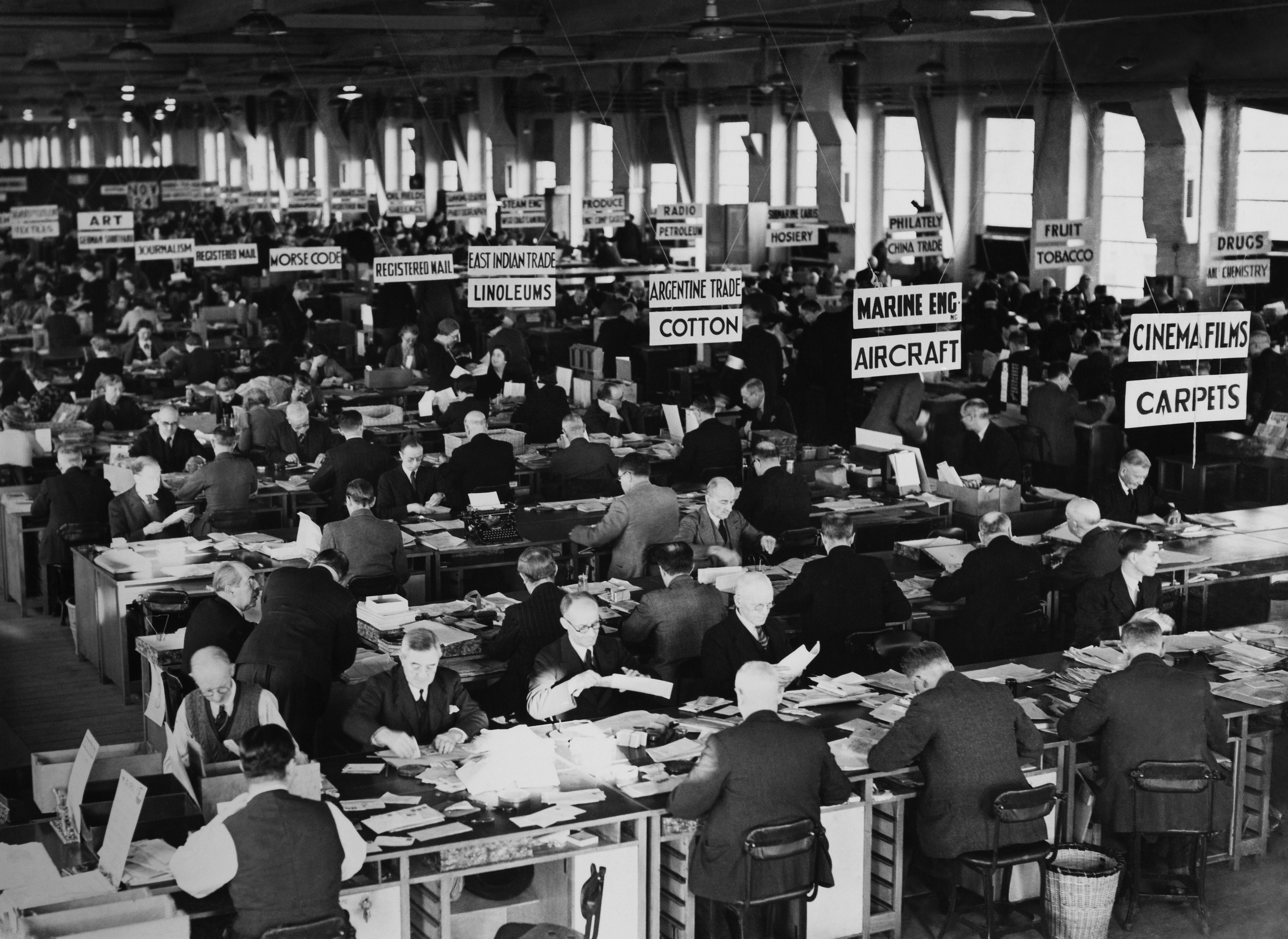 Busy banal  speech   level  with galore   traders moving   astatine  desks, signs for assorted  commodities and products hanging overhead