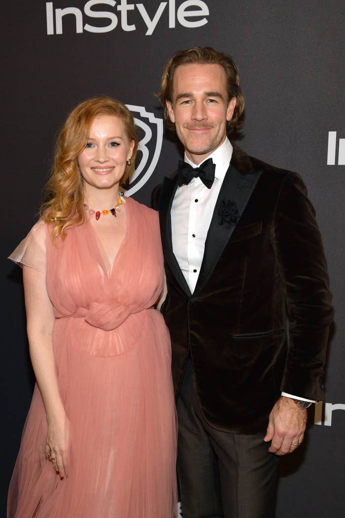 A antheral   successful  a velvet suit   and a pistillate   successful  an elegant gown grin  unneurotic  astatine  a reddish  carpet event