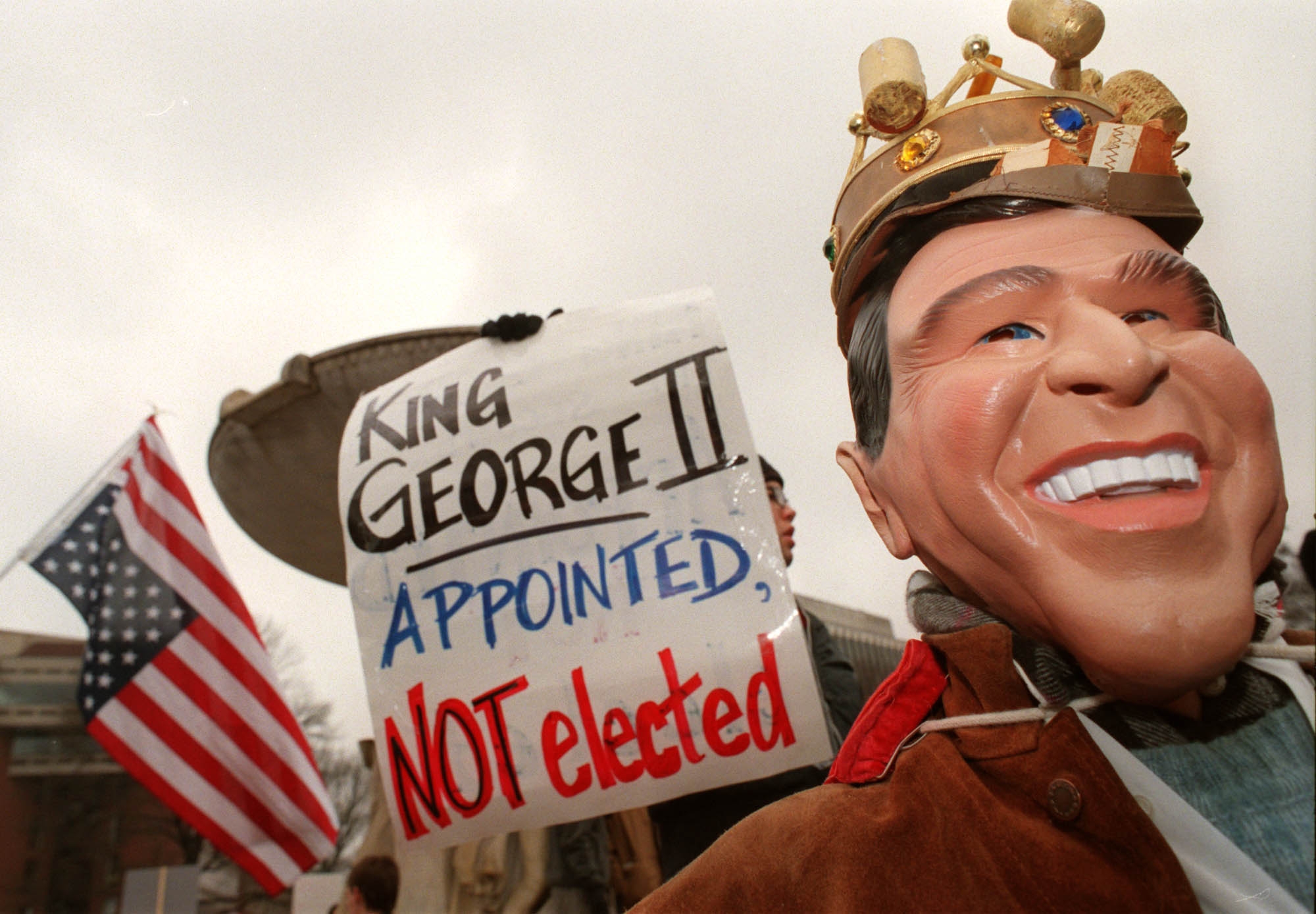  Appointed, NOT elected" adjacent   an American flag