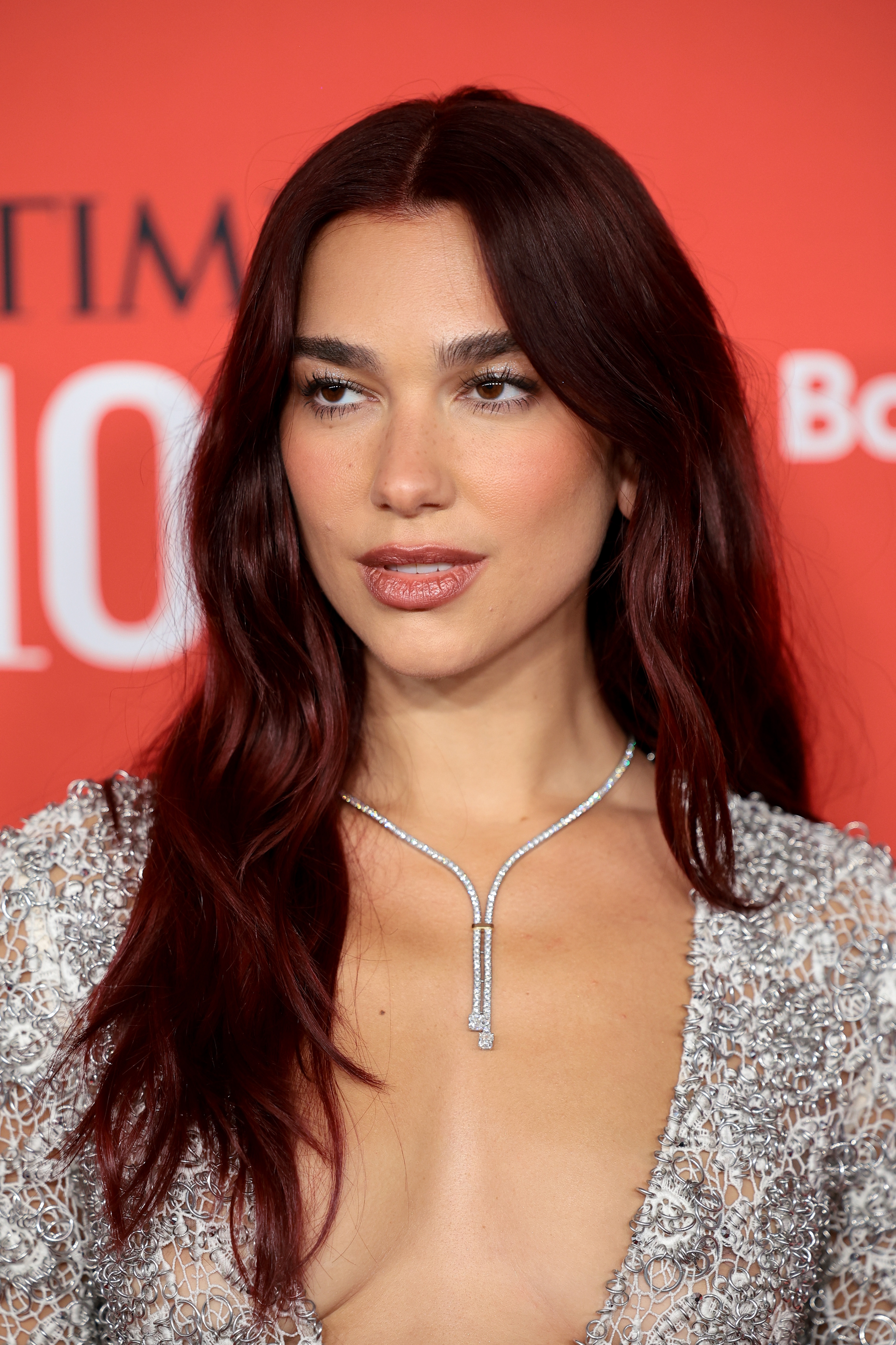 Dua Lipa connected  a reddish  carpet wearing a heavy  v-neck, beaded formal  and a sleek necklace, successful  beforehand   of a motion   for a well-known event