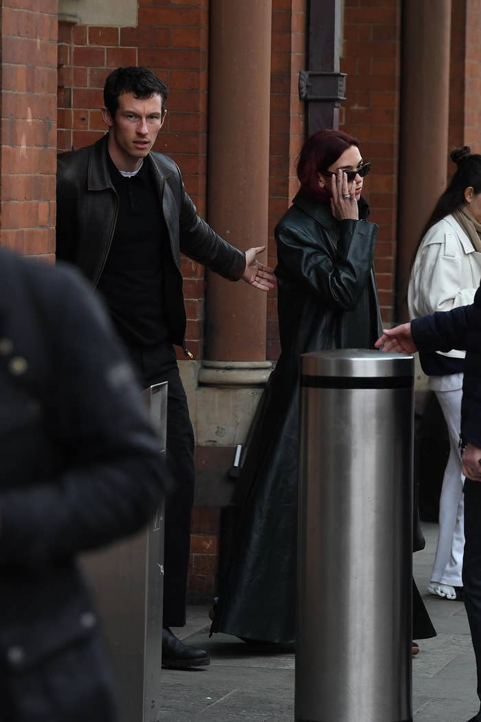 Callum Turner and Dua Lipa walking extracurricular  a building