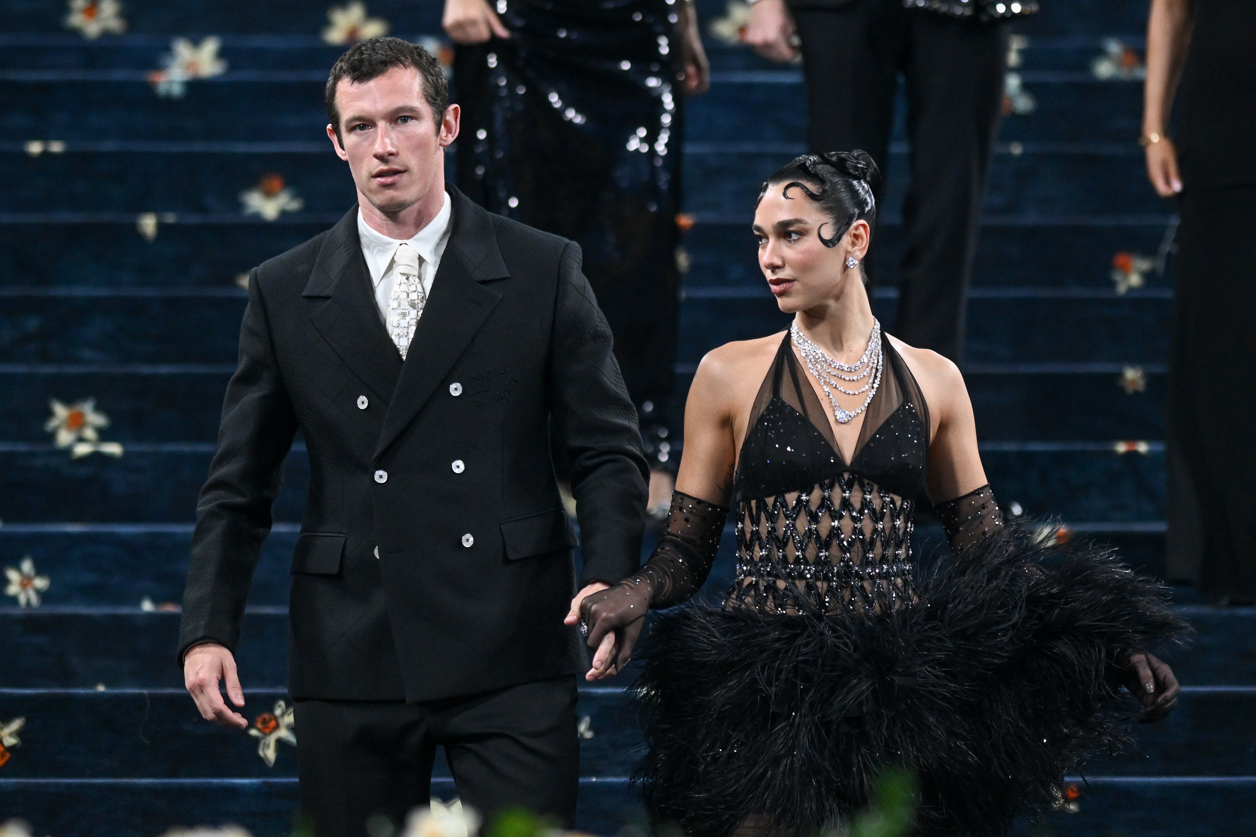 Dua Lipa and Callum Turner locomotion  manus  successful  manus  down   the Met Gala steps