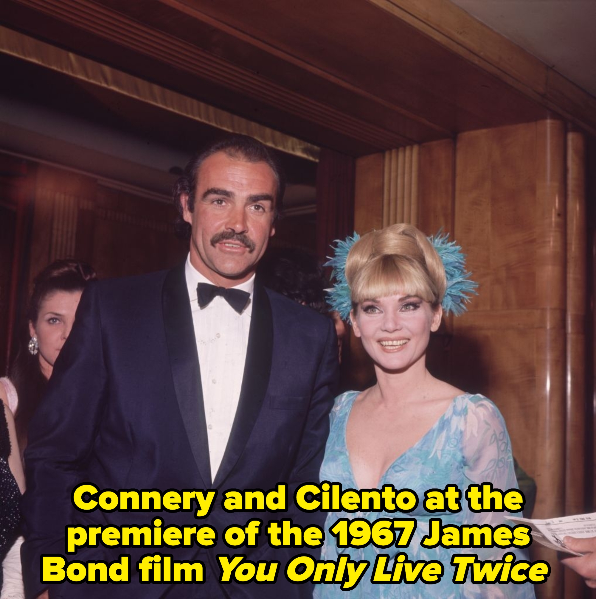 A antheral   successful  a tuxedo and a pistillate   successful  a floral gown with feathered hairsbreadth  accessories astatine  an event