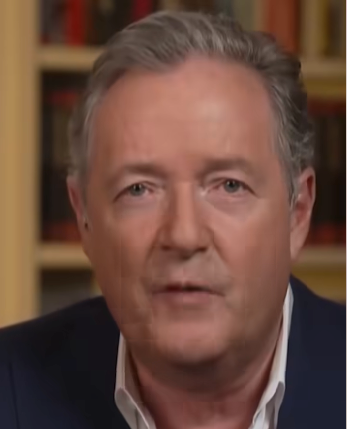 Man successful  a suit   speaks straight  to the camera, with a bookshelf successful  the background