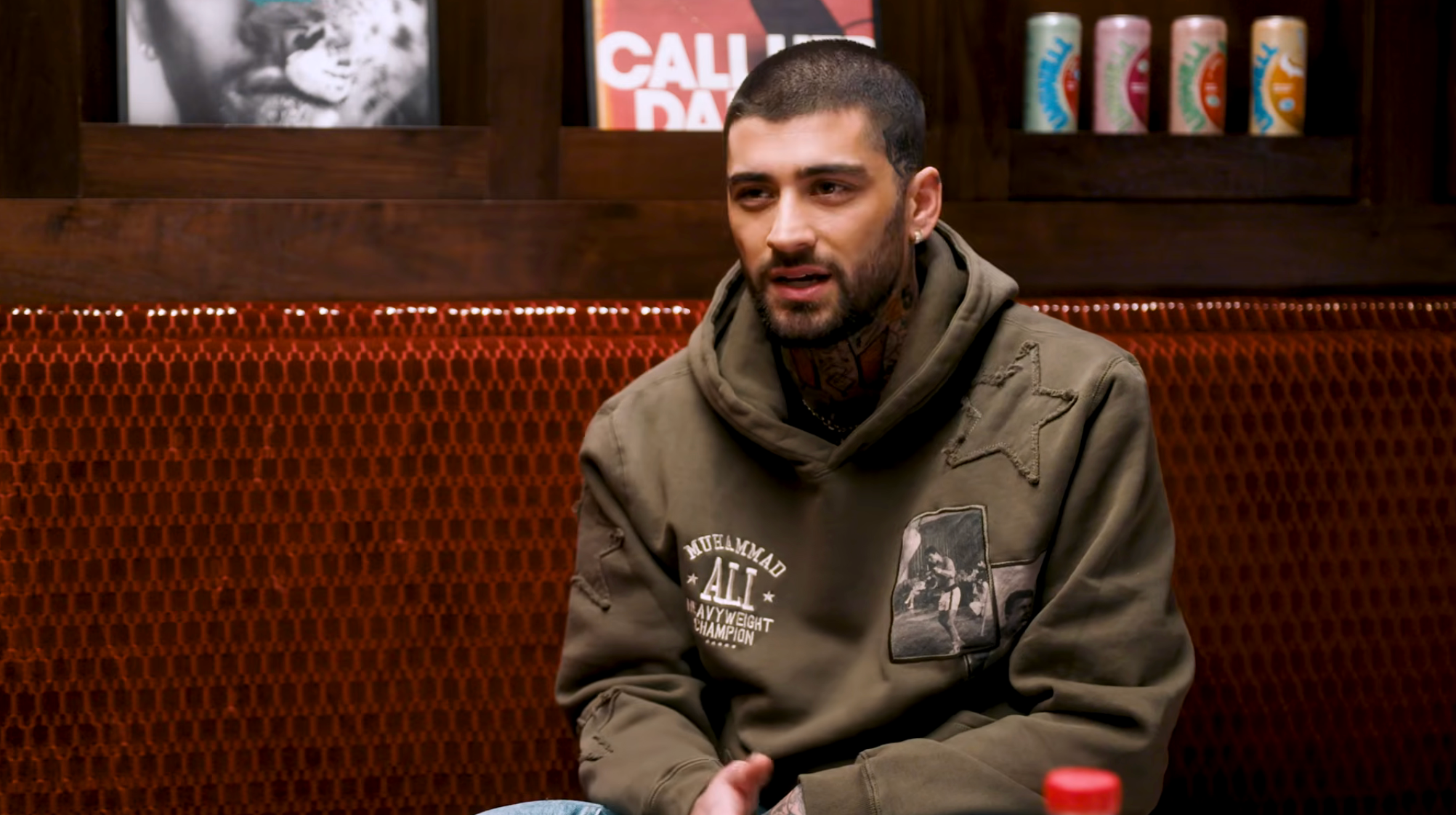 Person sitting successful  a cozy country   with vintage decor, wearing a casual hoodie with graphic patches, engaged successful  conversation