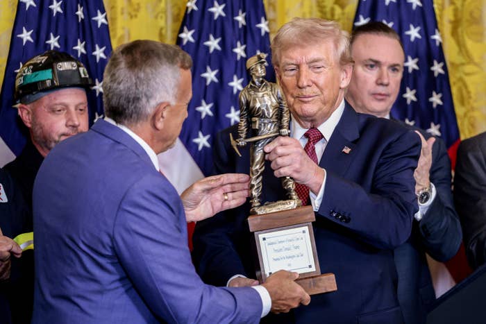 Trump receiving his caller   champion   of ember  trophy