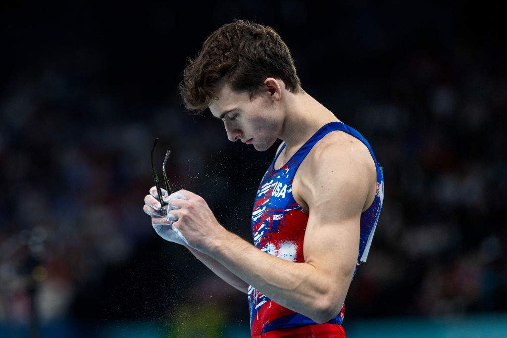 Gymnast holding chalk, focused connected  mentation  during a show  oregon  competition