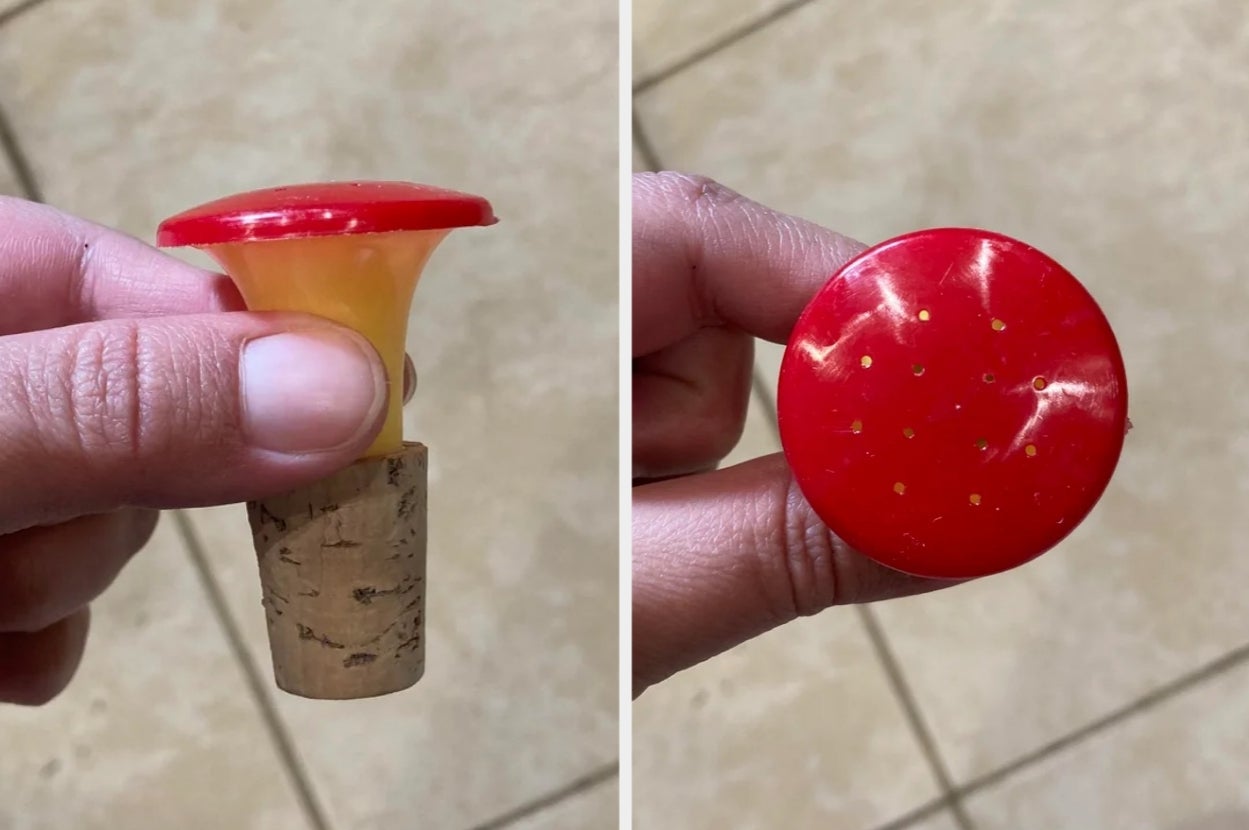 Close-up of a hand holding a red plastic and cork combination corkscrew opener, showing top and side views
