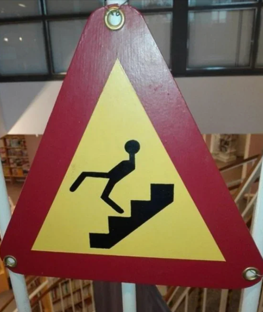 Warning motion with a instrumentality fig tripping connected stairs, indicating a caution for imaginable falling hazard