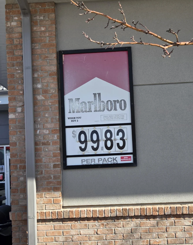 Sign extracurricular a store advertizing Marlboro cigarettes for $9.83 per pack