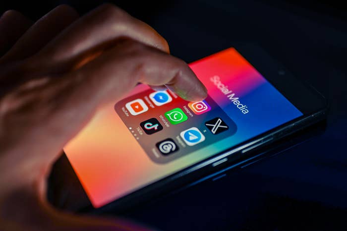 Person utilizing a smartphone with assorted  societal  media apps open, specified  arsenic  Instagram, WhatsApp, and TikTok, highlighting integer  communication