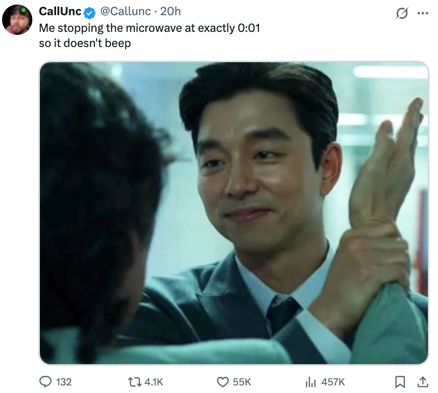 Man smiling and holding different  person's limb  successful  a humorous meme astir  stopping a microwave earlier  it beeps