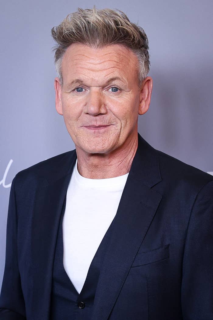 Person successful  a acheronian  suit   and achromatic  garment  astatine  a ceremonial  event, smiling astatine  the camera