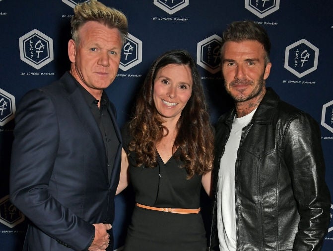 1 successful a suit, 1 successful a dress, and 1 successful a leather overgarment with jeans, smiling for the camera