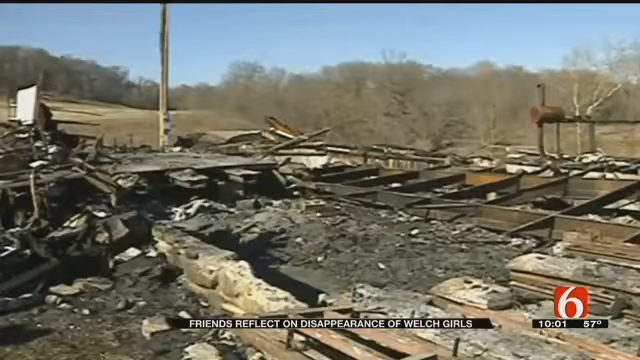 Burned remains of a gathering  with debris scattered. Caption notes friends reflecting connected  the disappearance of Welch Girls