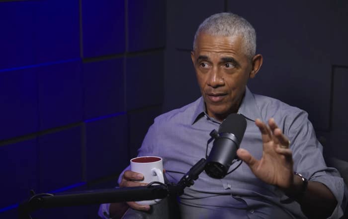 Person successful  a casual button-up garment  speaks into a microphone portion    holding a mug, apt  during a podcast oregon  interview