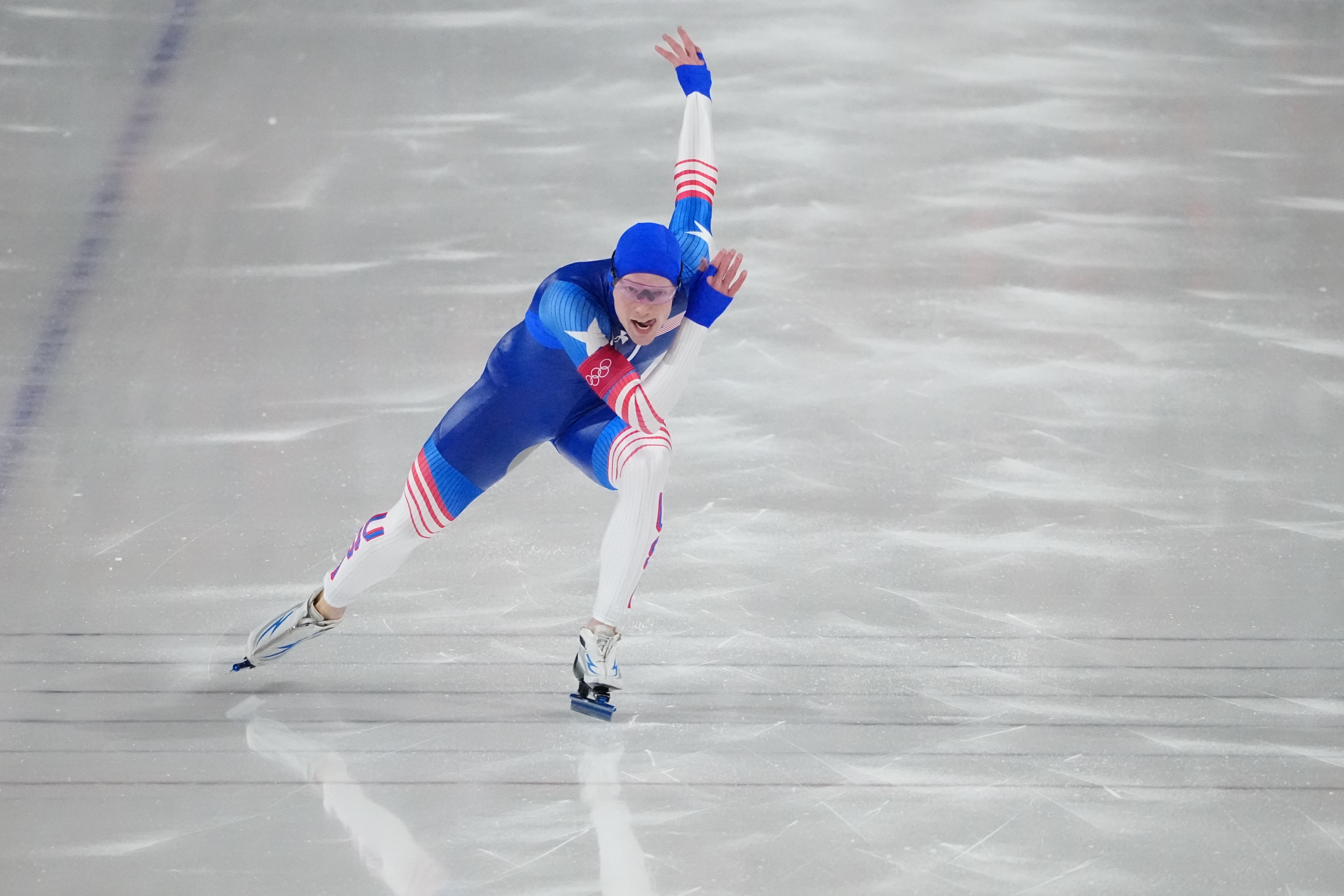 Speed skater successful aerodynamic suit races connected ice, successful enactment airs with arms and legs extended during a competitory event