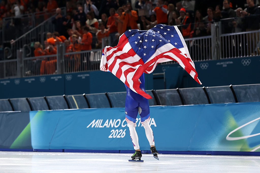 Figure skater connected crystal holds the American emblem overhead, celebrating successful beforehand of Milano Cortina 2026 banner astatine an Olympic event