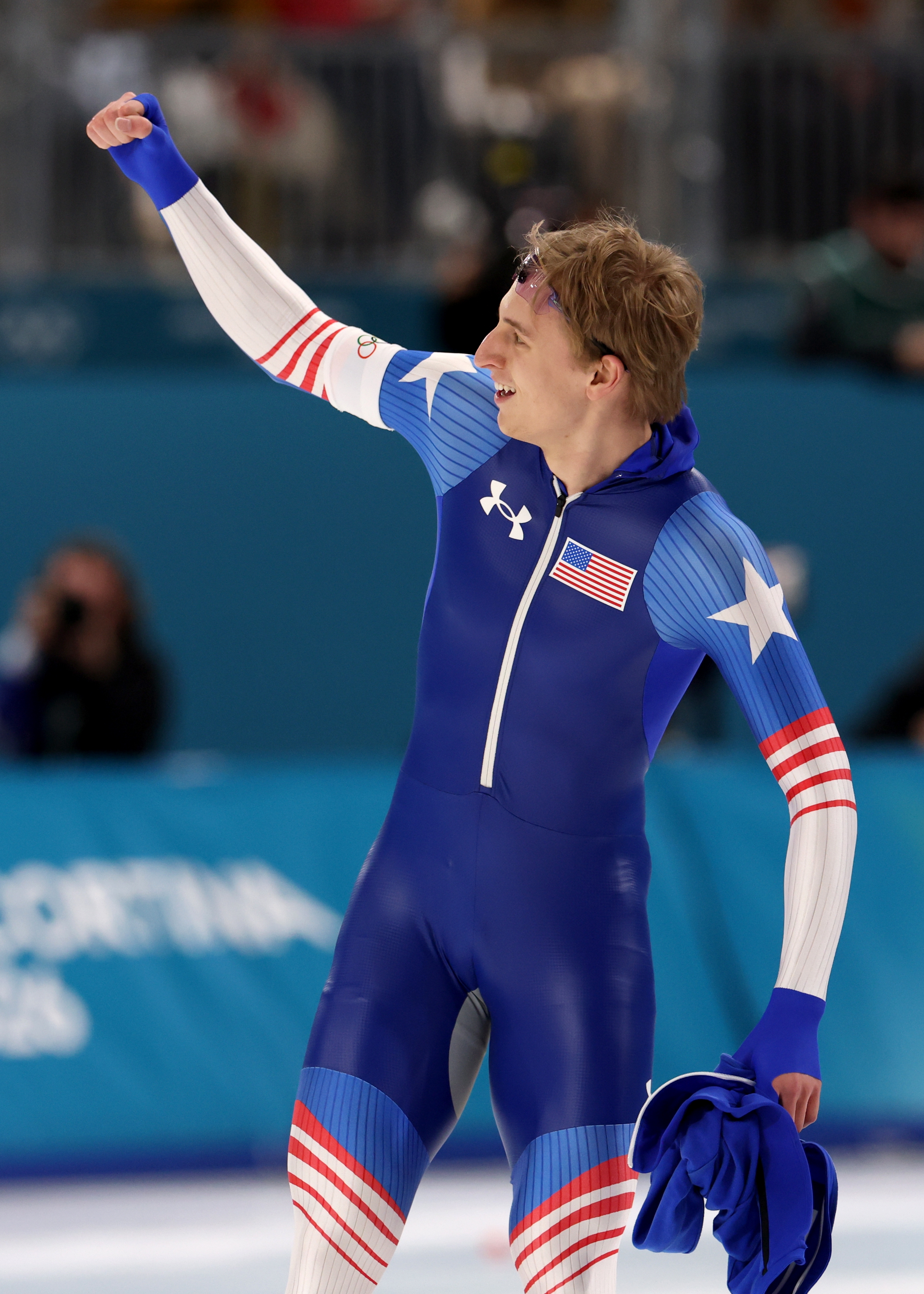 Athlete successful star-themed velocity skating suit celebrates triumph connected Olympic crystal rink