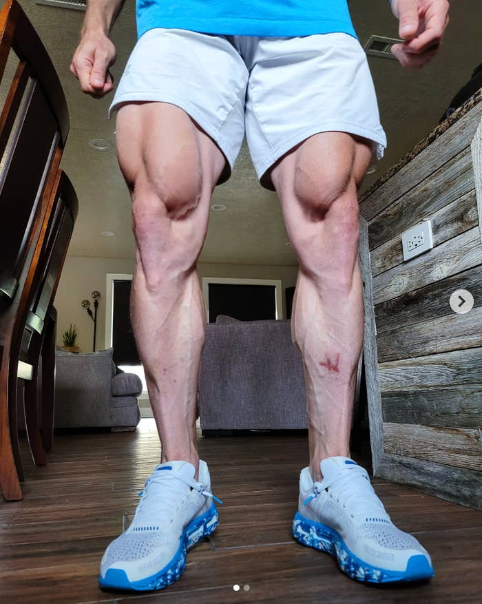 Close-up of a idiosyncratic   lasting  indoors, showing muscular legs, wearing achromatic  shorts and diversion  sneakers
