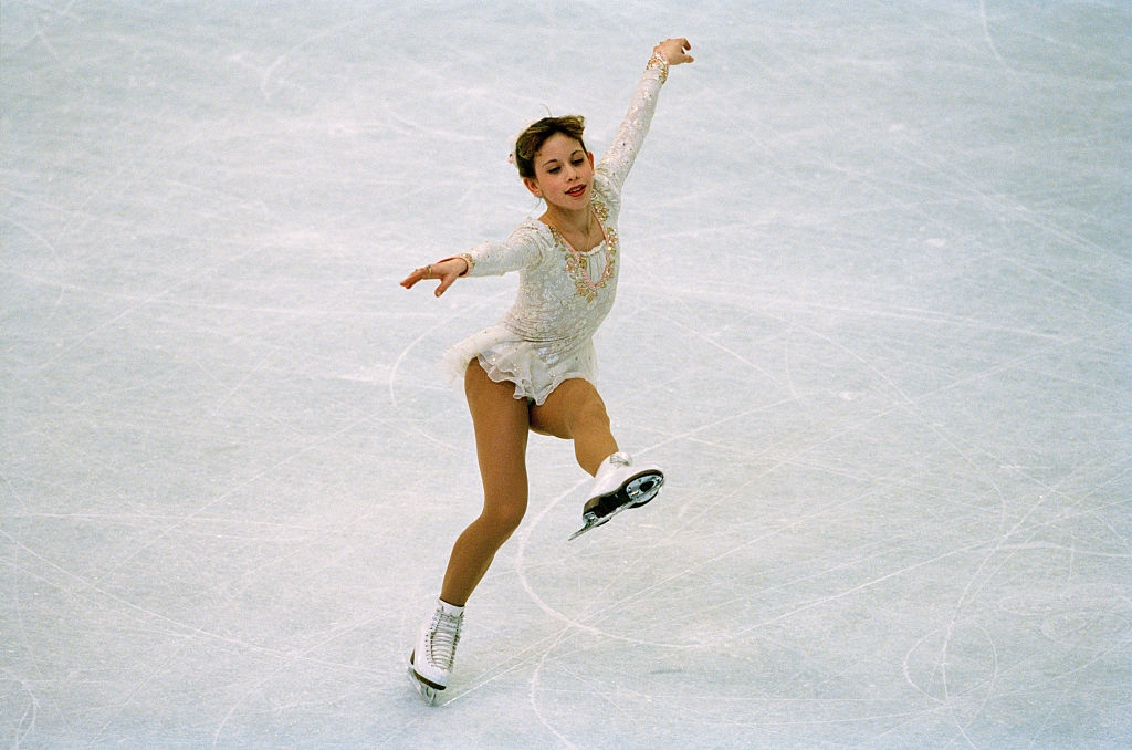 Figure skater performing a graceful regular connected ice, wearing a sparkling, elegant skating dress