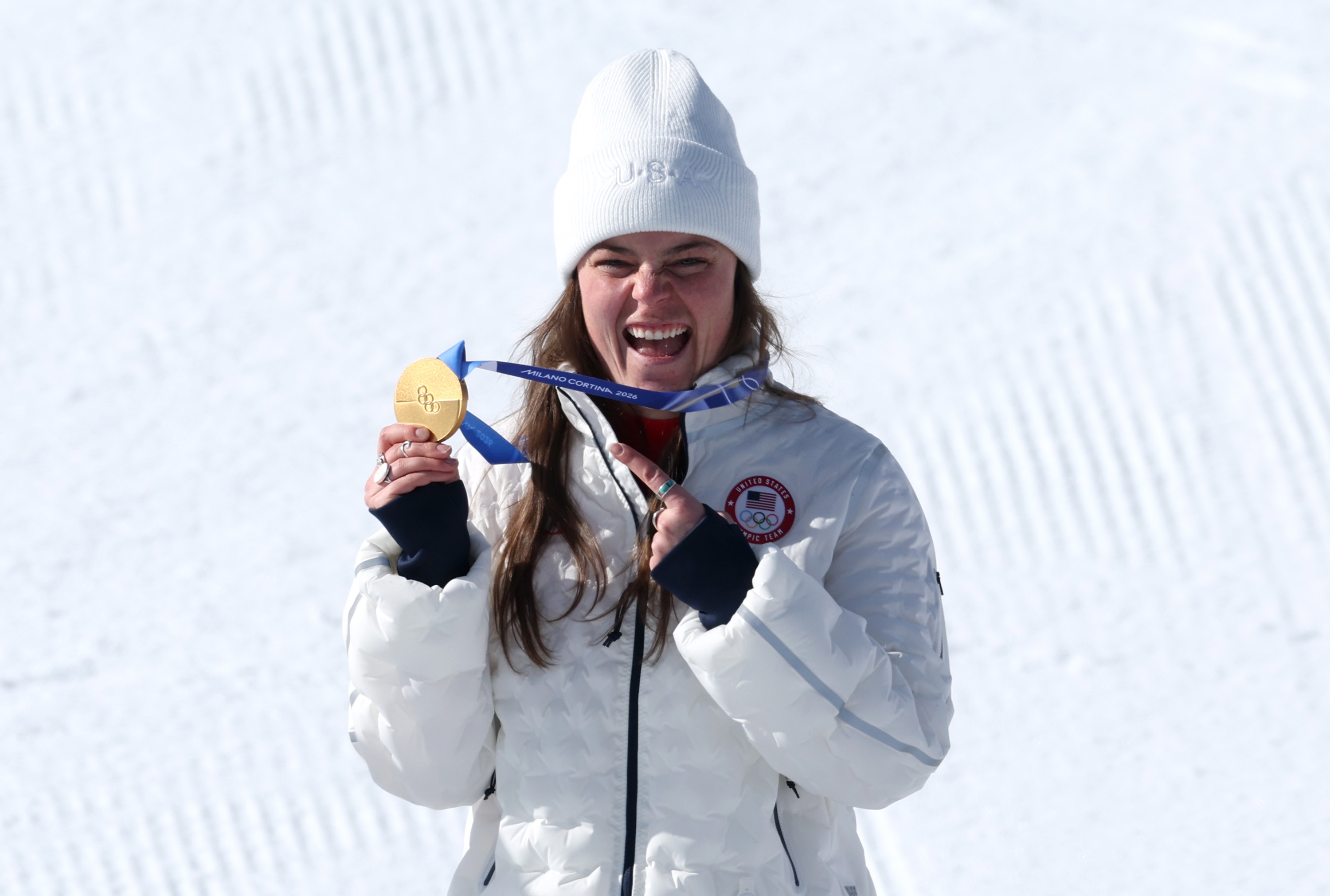 Breezy Johnosn smiling and holding a golden  medal
