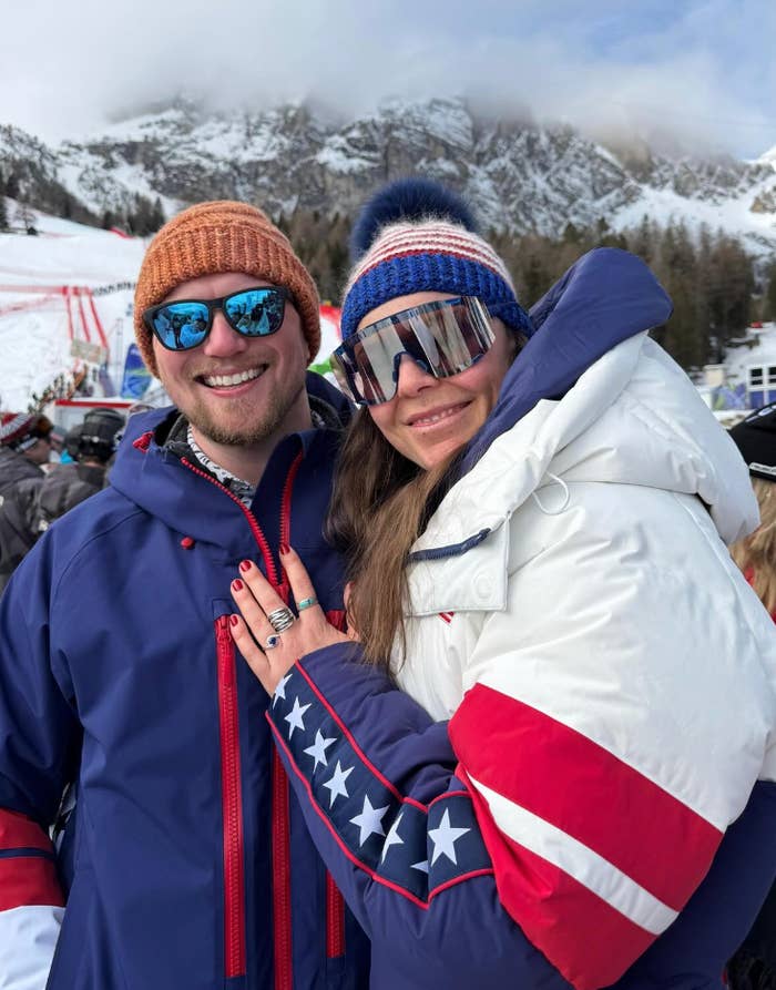 Connor and Breezy smiling connected  a snowy mountain