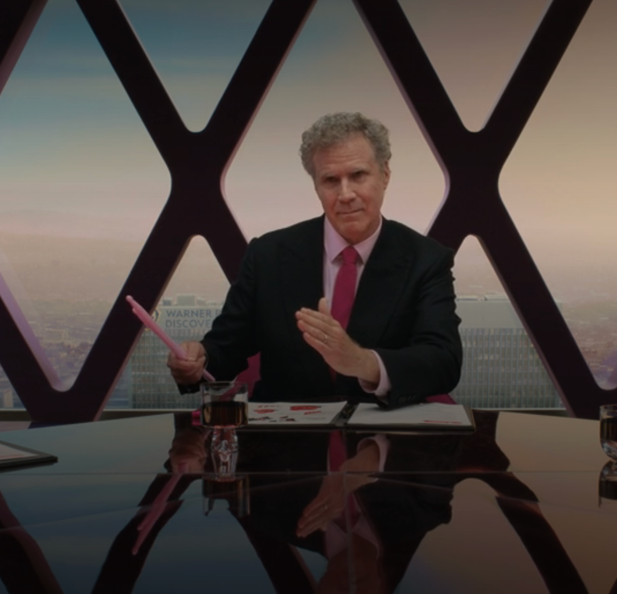 Will Ferrell arsenic  th CEO successful  "Barbie," wearing a sui and seated astatine  the caput  of a table