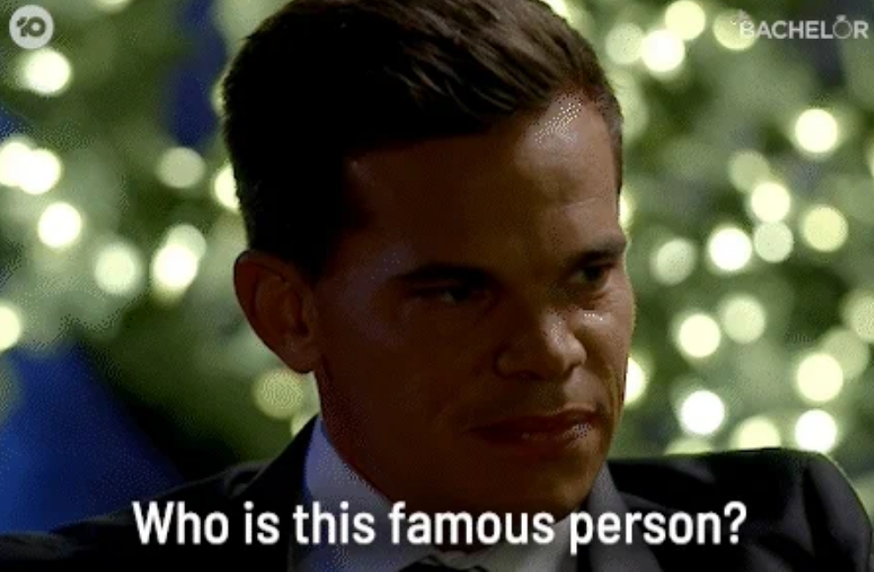 A antheral   with a quizzical look  is seen sitting, captioned "Who is this celebrated  person?" Strings of lights make  a blurred inheritance  effect