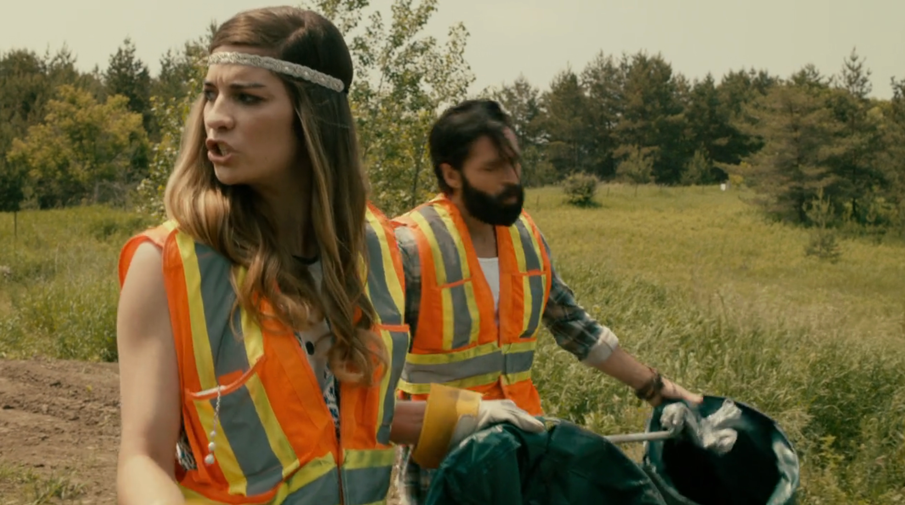 Alexis Rose and Mutt picking up   trash successful  reflective vests connected  "Schitt's Creek"