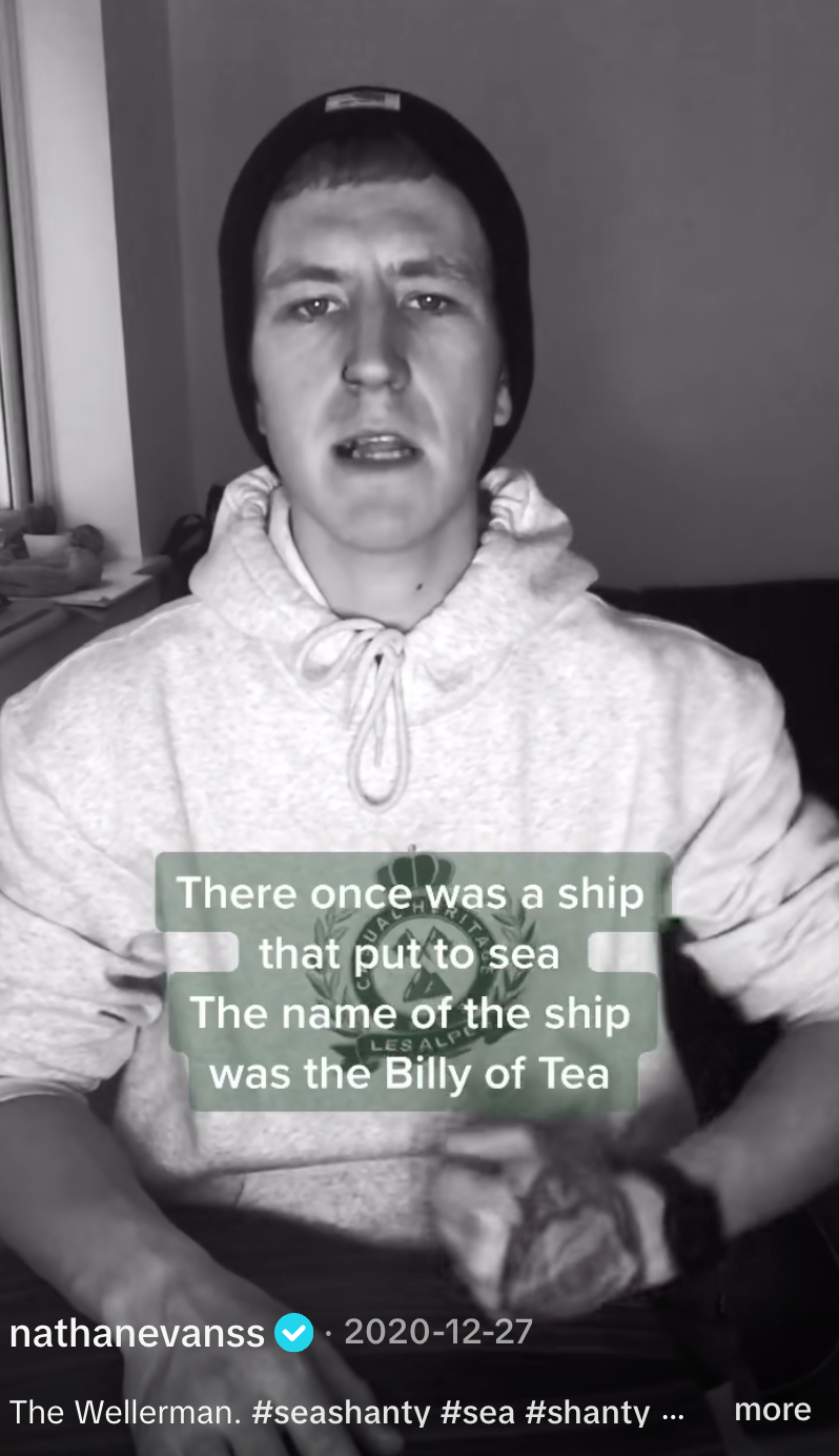 Person in casual hoodie singing with visible text overlay of "The Wellerman" lyrics from a TikTok video