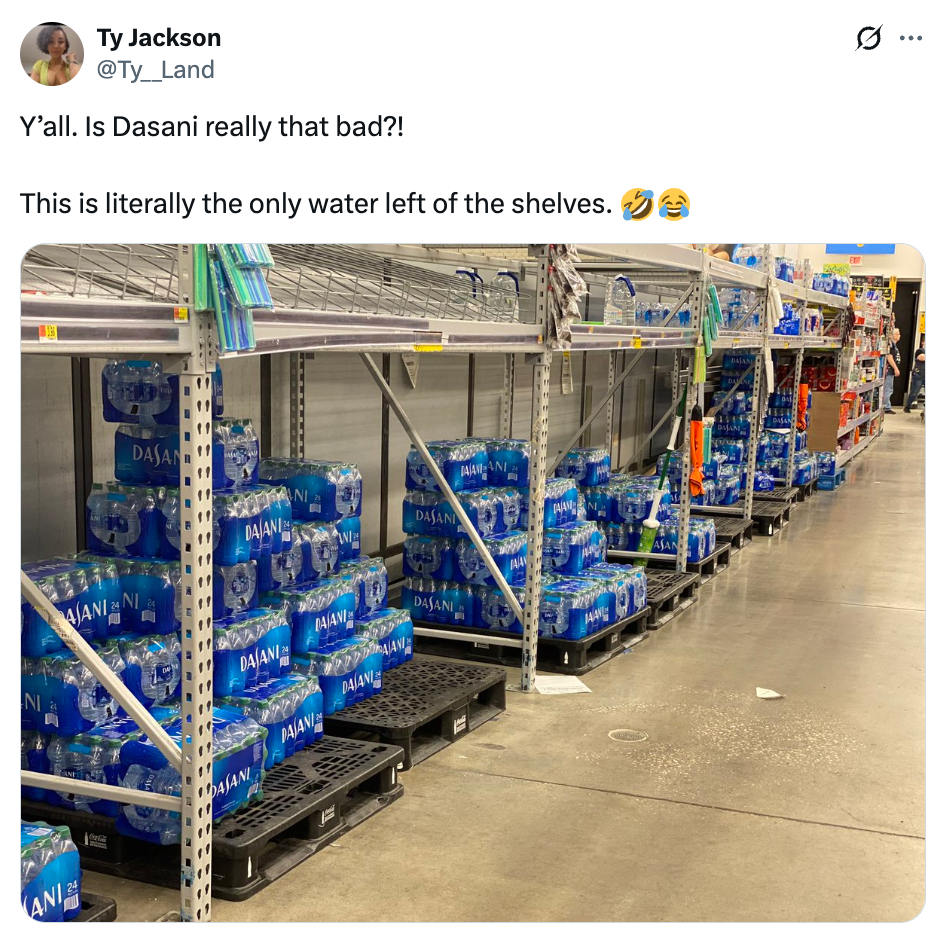 Store shelves mostly empty, except for stacks of Dasani water bottles, suggesting low demand as noted humorously in the post