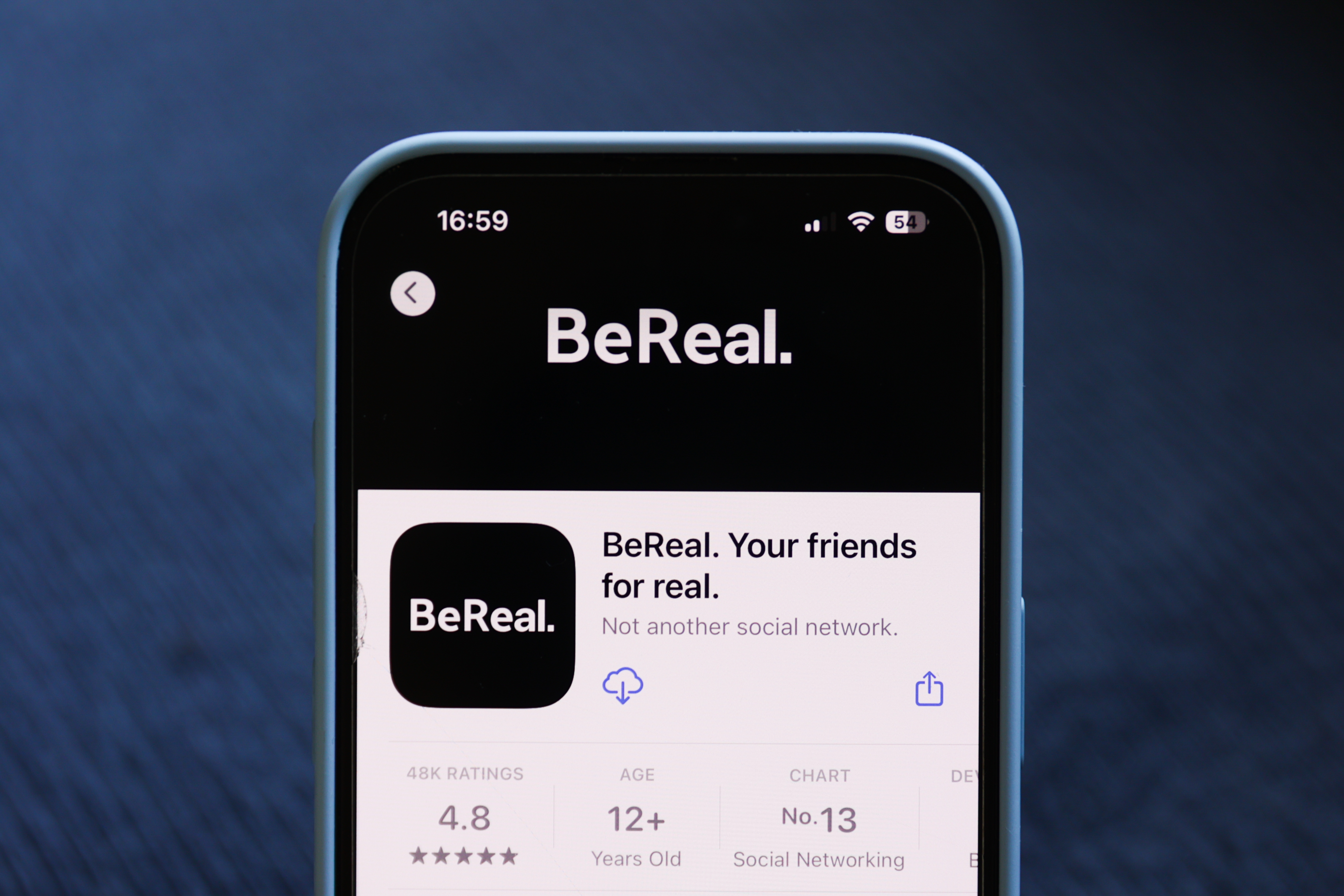BeReal app page displayed on a smartphone screen, highlighting its slogan "Your friends for real" and rating