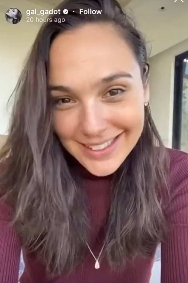 Person in a maroon top smiles at the camera during a video message