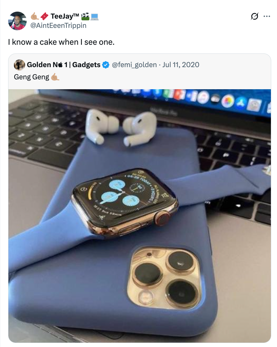 A smartwatch and smartphone with matching blue cases placed on a laptop keyboard, with wireless earbuds nearby